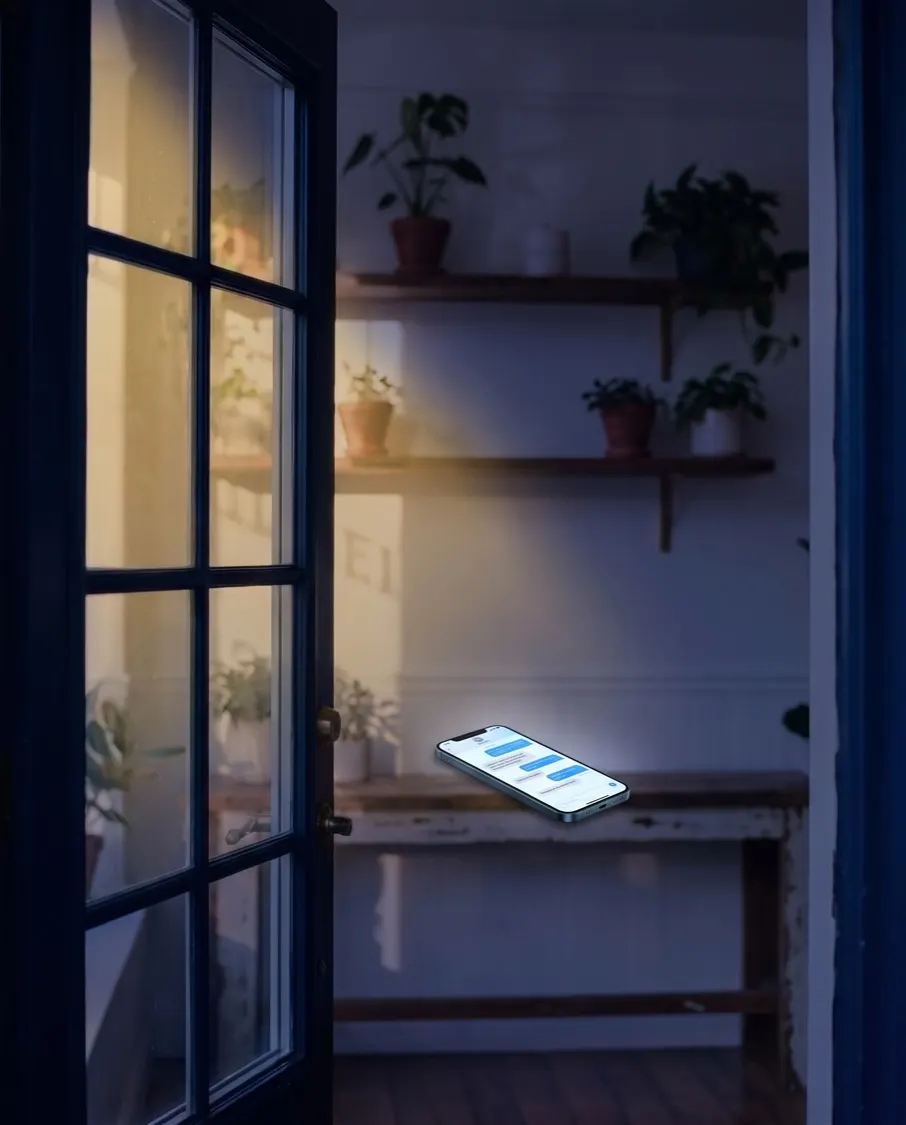 The closed shop at night, a phone on the counter lit with a chat